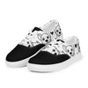 A pair of women's Orca Snork "Goofy Pup" canvas sneakers shown at a left front angle. The shoes feature a black and white dog print design with hand-drawn hearts and a solid black toe cap.